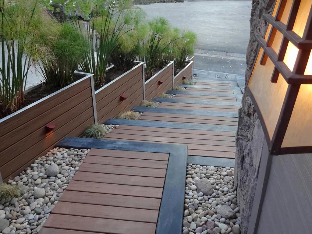 MoistureShield's Vantage composite decking stairs flanked by composite decking planters.
