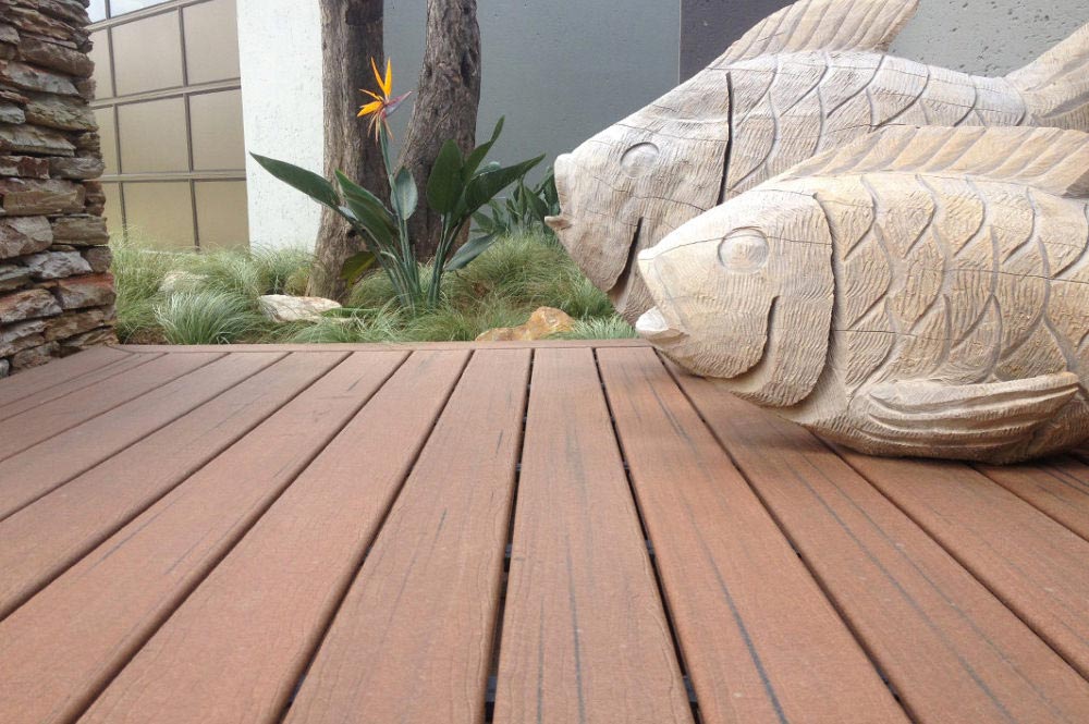 Composite deck closeup with ornamental fish statues.