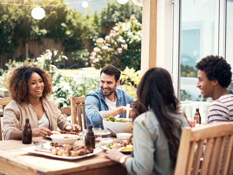 party People at outdoor dining table with food