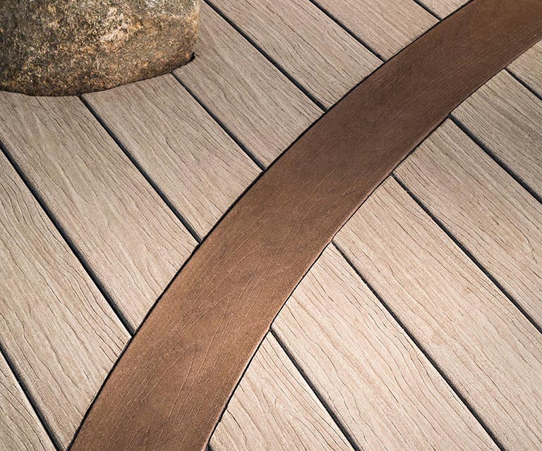 bg-diamonddefense Close overhead view of straight and curved composite decking boards.