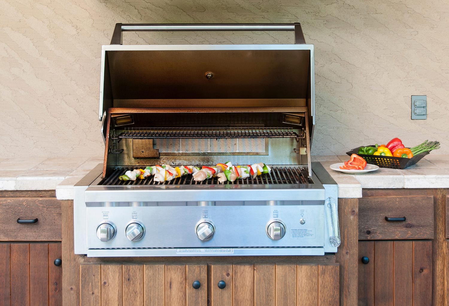 Grill with kabobs and wood cabinetry
