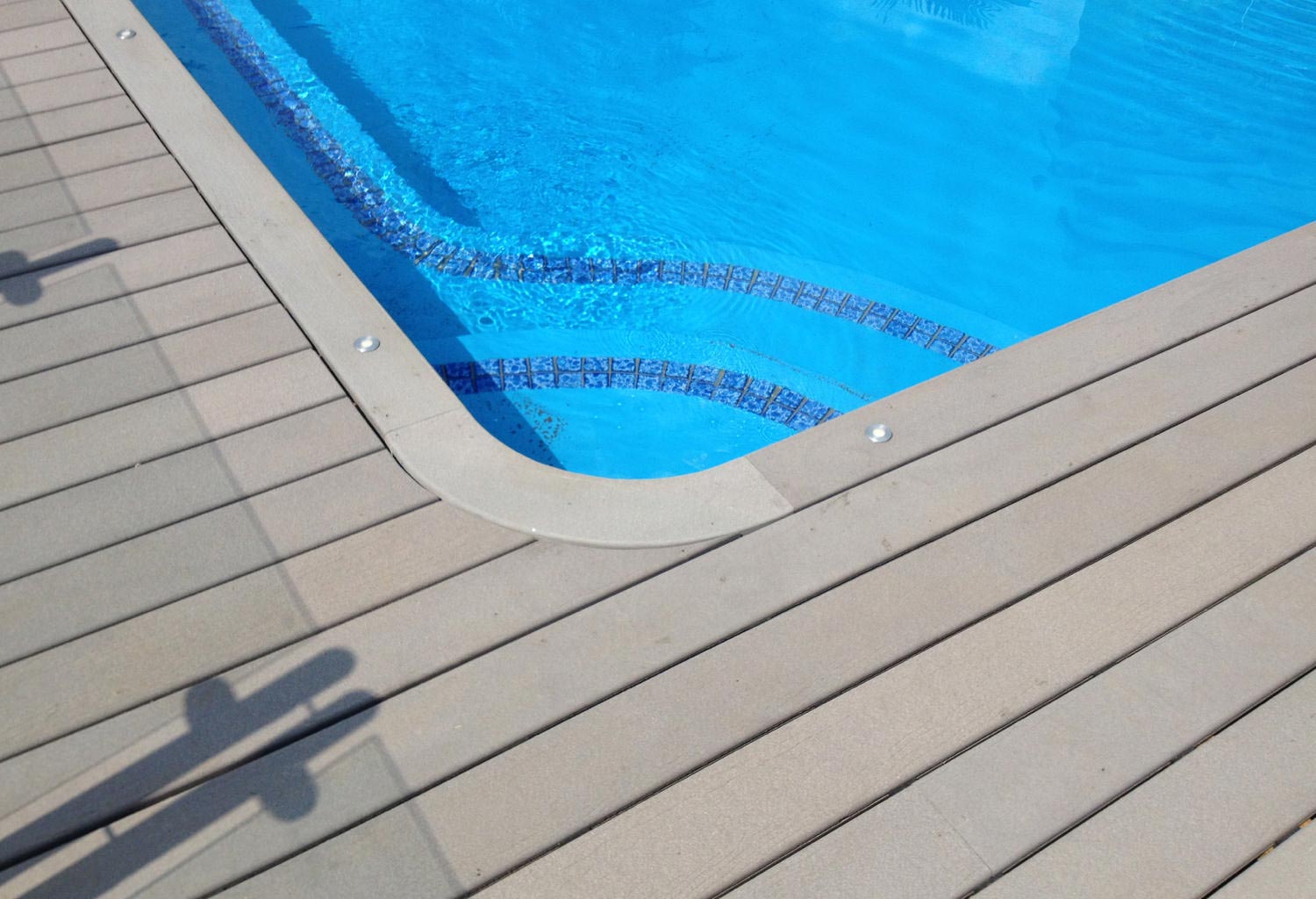 Overhead view of a pool corner and composite pool deck.