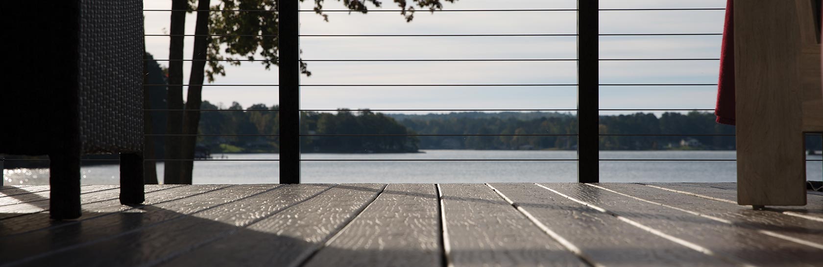 Close up of MoistureShield composite decking and a view of a lake.