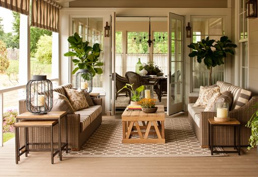 Covered composite deck with seating, plants, and French doors leading inside.