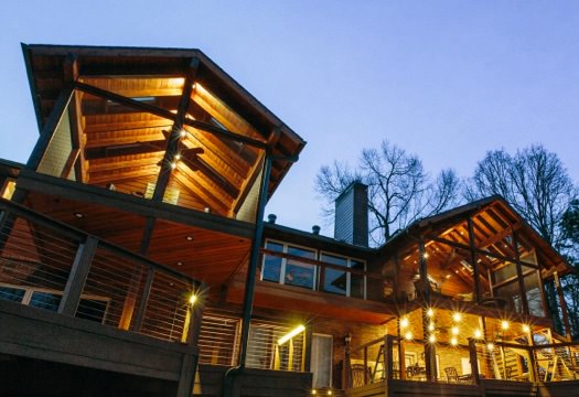 Upward view of a house with well-lit covered composite decks.