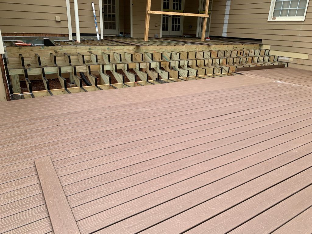 Joist tape-protected deck substructure with MoistureShield composite decking boards.
